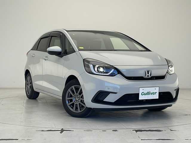 ホンダ フィット e:HEVホーム 沖縄県 2021(令3)年 4.7万km プレミアムサンライトホワイトパール 純正8インチナビ（VXM-215VFEi）/フルセグ/Ｂｌｕｅｔｏｏ/ＣＤ/ＤＶＤ/ＵＳＢ　/バックカメラ/ＥＴＣ　/クルーズコントロール　/チップアップシート　/ハーフレザーシート　/電格ミラー　/前後コーナーセンサー/純正15インチAW/純正フロアマット/プッシュスタート/スマートキ―/スペアキー