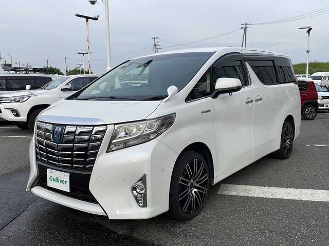 トヨタ アルファードハイブリット G 新潟県 2016(平28)年 11万km ホワイトパールクリスタルシャイン メーカーオプションナビ/フルセグTV/BT/CD/DVD/AUX/バックカメラ/JBL/両側パワースライドドア/フリップダウンモニター/レーダークルーズコントロール/ETC/4WD/オットマン/D＋N席　パワーシート/ドライブレコーダー前後/ナノイーエアコン/スペアキー1本/スマートキー/社外19インチアルミホイール/ウォークスルー