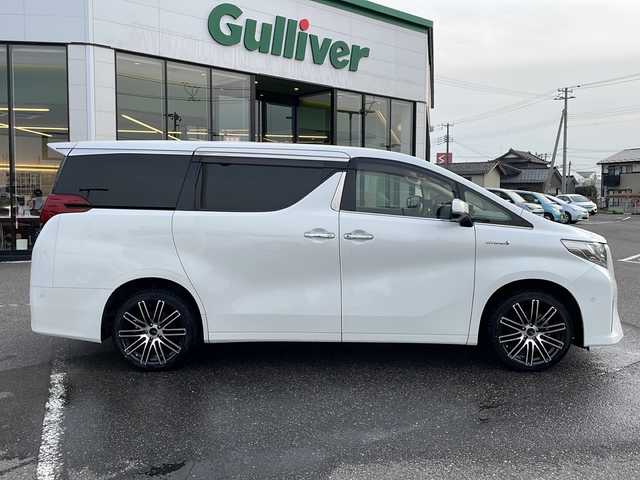 トヨタ アルファードハイブリット G 新潟県 2016(平28)年 11万km ホワイトパールクリスタルシャイン メーカーオプションナビ/フルセグTV/BT/CD/DVD/AUX/バックカメラ/JBL/両側パワースライドドア/フリップダウンモニター/レーダークルーズコントロール/ETC/4WD/オットマン/D＋N席　パワーシート/ドライブレコーダー前後/ナノイーエアコン/スペアキー1本/スマートキー/社外19インチアルミホイール/ウォークスルー