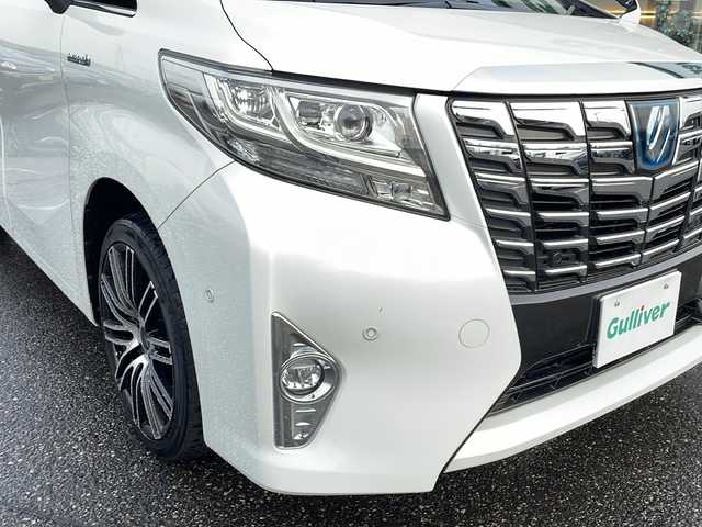 トヨタ アルファードハイブリット G 新潟県 2016(平28)年 11万km ホワイトパールクリスタルシャイン メーカーオプションナビ/フルセグTV/BT/CD/DVD/AUX/バックカメラ/JBL/両側パワースライドドア/フリップダウンモニター/レーダークルーズコントロール/ETC/4WD/オットマン/D＋N席　パワーシート/ドライブレコーダー前後/ナノイーエアコン/スペアキー1本/スマートキー/社外19インチアルミホイール/ウォークスルー