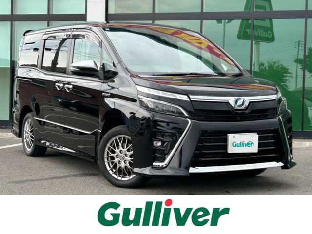 トヨタ ヴォクシー ハイブリッド ZS 煌Ⅱ 和歌山県 2019(令1)年 6.2万km ブラック 純正ナビ（NSZT-Y68T）/フルセグTV/（BT/CD/DVD）/バックカメラ/横滑り防止/衝突被害軽減ブレーキ/レーンキープアシスト/クルーズコントロール/オートライト/前後コーナーセンサー/フリップダウンモニター/前方ドラレコ/ビルトインETC/両側パワスラ/前席シートヒーター/LEDヘッドライト/フォグランプ/ステアリングリモコン/ステアリングヒーター/純正16インチアルミ/純正フロアマット