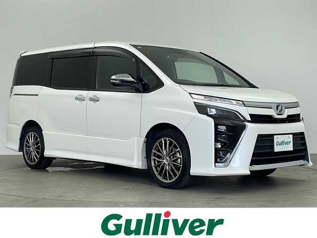 トヨタ ヴォクシー ZS 煌 鹿児島県 2018(平30)年 7.2万km ホワイトパールクリスタルシャイン Toyota Safety Sense/純正10型ナビ/Bluetooth HDMI DVD/フルセグTV/バックカメラ/純正12.1型フリップダウンモニター/両側電動スライドドア/クルーズコントロール/前方ドライブレコーダー/ビルトインETC2.0/レーンキープアシスト /プリクラッシュセーフティ/前後コーナーセンサー/LEDヘッドライト/フォグライト /オートライトコントロール/オートハイビーム /社外17インチアルミホイール/純正フロアマット/スマートキー/エンジンプッシュスタート/保証書