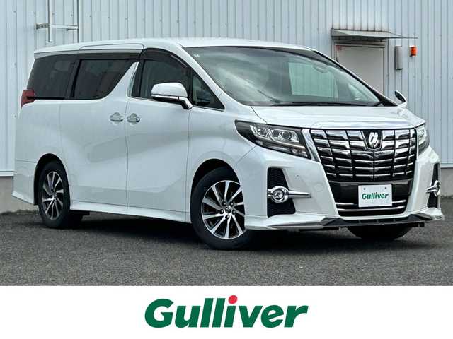 トヨタ アルファード S Cパッケージ 熊本県 2015(平27)年 7.1万km ホワイトパールクリスタルシャイン 社外ナビ（ALPINE）/・AM/FM/CD/DVD/SD/USB/HDMI/BT/・フルセグTV/バックカメラ/横滑り防止機能/クリアランスソナー/クルーズコントロール/前後コーナーセンサー/革巻きステアリング/・ステアリングリモコン/・ステアリングヒーター/レザーシート/・D/N席パワーシート/・D席シートメモリー/・N席＋二列目オットマン/オートライト/・LEDライト/・フォグランプ/フリップダウンモニター（ALPINE）/電動格納ミラー/・ウィンカーミラー/前後ドライブレコーダー（ZDR016）/電動サイドブレーキ/・ホールドボタン/パワーバックドア/ETC/ドアバイザー/純正アルミホイール/社外フロアマット/スマートキー/・スペアキー/社外フロアマット