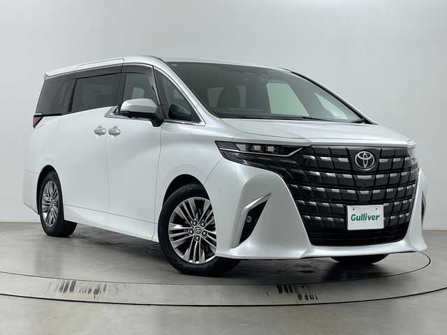 トヨタ アルファードハイブリット Z 埼玉県 2024(令6)年 1.4万km プラチナホワイトパールマイカ 独立ムーンルーフ/後席モニター　/純正１２．３インチナビ機能付きディスプレイオーディオ　/全方位カメラ　/ＢＳＭ　/前後ドライブレコーダー　/ビルトインＥＴＣ２．０　/デジタルインナーミラー　/自動駐車システム　/アダプティブクルーズコントロール/レーンキープアシスト/衝突軽減システム/シートヒーター/エアシート/パワーシート/電動リアゲート/オートブレーキホールド/電子パーキング/オートマティックハイビーム/前後コーナーセンサー/ワイヤレス充電器/オットマン/１００V充電/ヘッドアップディスプレイ/パドルシフト/純正アルミホイール/純正フロアマット/LEDヘッドライト