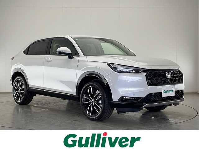 ホンダ ヴェゼル ハイブリッド e:HEV Z 宮崎県 2025(令7)年 0.1千km プラチナホワイトパール 禁煙車/ホンダセンシング/純正9型ディスプレイオーディオナビTV/（3VC4AG3/Honda CONNECT/FMAM/Bluetooth/フルセグTV）/純正ビルトインETC2.0車載器/純正フロントグリル（ベルリナブラック）/純正LEDオートライト/純正LEDフォグ/純正18インチアルミ/アダプティブクルーズコントロール/レーンディパーチャーアラート/ダウンヒルアシストコントロール/ブラインドスポットモニター/クリアランスソナー/ワイヤレス充電器/ハーフレザーシート/前席シートヒーター/ステアリングヒーター/デュアルオートエアコン/パワーバックドア/スマートキー/プッシュエンジンスタート/スペアキー/新車時保証書/取扱い説明書