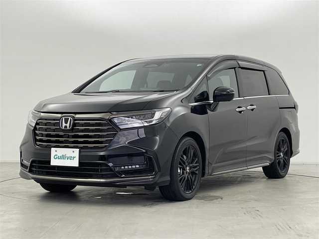 ホンダ オデッセイ ハイブリッド e:HEVアブソルート EXブラックED 群馬県 2024(令6)年 1万km 黒 純正11.4インチナビ/　(AM/FM/CD/DVD/SD/Bluetooth/フルセグTV/AppleCarPlay/AndroidAuto)/純正15.6インチフリップダウンモニター/マルチビューカメラシステム/純正前後ドライブレコーダー　（DRH-229ND）/ハンズフリーアクセスパワーテールゲート/両側パワースライドドア/本革シート/前席パワーシート/2列目両側アームレスト付4ウェイパワーシート/　(リクライニング/オットマン)/前席/2列目シートヒーター/ホンダセンシング/・衝突軽減ブレーキ/近距離衝突軽減ブレーキ/・路外逸脱抑制機能/車線維持支援システム/歩行者事故低減ステアリング/・渋滞追従機能付アダプティブクルーズコントロール/・オートハイビーム/・ブラインドスポットインフォメーション/パーキングセンサーシステム/・標識認識機能/先行車発進お知らせ機能/・誤発進抑制機能/後方誤発進抑制機能/・後退出庫サポート/急アクセル抑制機能/18インチアルミホイール マットベルリナブラック/ワイヤレス充電