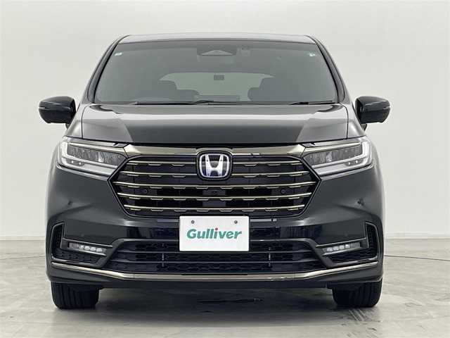 ホンダ オデッセイ ハイブリッド e:HEVアブソルート EXブラックED 群馬県 2024(令6)年 1万km 黒 純正11.4インチナビ/　(AM/FM/CD/DVD/SD/Bluetooth/フルセグTV/AppleCarPlay/AndroidAuto)/純正15.6インチフリップダウンモニター/マルチビューカメラシステム/純正前後ドライブレコーダー　（DRH-229ND）/ハンズフリーアクセスパワーテールゲート/両側パワースライドドア/本革シート/前席パワーシート/2列目両側アームレスト付4ウェイパワーシート/　(リクライニング/オットマン)/前席/2列目シートヒーター/ホンダセンシング/・衝突軽減ブレーキ/近距離衝突軽減ブレーキ/・路外逸脱抑制機能/車線維持支援システム/歩行者事故低減ステアリング/・渋滞追従機能付アダプティブクルーズコントロール/・オートハイビーム/・ブラインドスポットインフォメーション/パーキングセンサーシステム/・標識認識機能/先行車発進お知らせ機能/・誤発進抑制機能/後方誤発進抑制機能/・後退出庫サポート/急アクセル抑制機能/18インチアルミホイール マットベルリナブラック/ワイヤレス充電