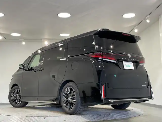 トヨタ ヴェルファイア ハイブリット Z プレミア 愛知県 2025(令7)年 0.5万km ブラック 純正１４インチディスプレイオーディオＰｌｕｓ　/（FM/AM/Bluetooth/フルセグTV/Miracast/HDMI/USB)/左右独立ムーンルーフ　/純正１３．２型フリップダウンモニター　/ユニバ―サールステップ　/パノラミックビューモニター　/トヨタチームメイト　/　　-アドバンスドパーク＋アドバンスドドライブ/　　-パーキングサポートブレーキ/トヨタセーフティセンス　/　　-プリクラッシュセーフティ/　　-レーントレーシングアシスト＋レーンディパーチャーアラート/　　-緊急時操舵支援/　　-レーダークルーズコントロール/　　-アダプティブハイビームシステム/　　-ロードサインアシスト/　　-プロアクティブドライビングアシスト/　　-発進遅れ告知機能/両側パワースライドドア/電動バックドア/ＡＣ１００Ｖ/三眼LEDヘッドライト/置くだけ充電/デジタルインナーミラー/シートヒーター/シートベンチレーション/ステアリングヒーター/メモリー機能付パワーシート/ブラインドスポットモニター/ヘッドアップディスプレイ/ドライブレコーダー/パドルシフト/茶レザーシート