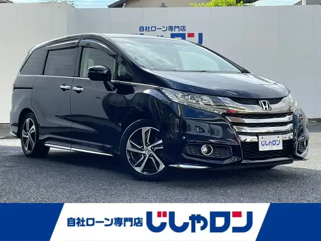 ホンダ オデッセイ アブソルート 埼玉県 2015(平27)年 10.4万km プレミアムヴィーナスブラックP (株)IDOMが運営する【じしゃロン鳩ヶ谷店】の自社ローン専用車両になりますこちらは現金またはオートローンご利用時の価格です。自社ローンご希望の方は別途その旨お申付け下さい/ホンダセンシング/  衝突軽減ブレーキ〈CMBS〉/  誤発進抑制機能/  LKAS〈車線維持支援システム〉/  路外逸脱抑制機能/  ACC〈アダプティブ・クルーズ・コントロール〉/純正ナビ　/　AM/FM/CD/DVD/BT/フルセグTV/バックカメラ　/フリップダウンモニター　/両側パワースライドドア　/パドルシフト　/ステアリングスイッチ　/デュアルエアコン　/キャプテンシート　/オットマン（２列目）/ビルトインＥＴＣ/フォグランプ/プッシュスタートボタン/スマートキー×2/ドアバイザー/電動格納式ウィンカーミラー/保証書