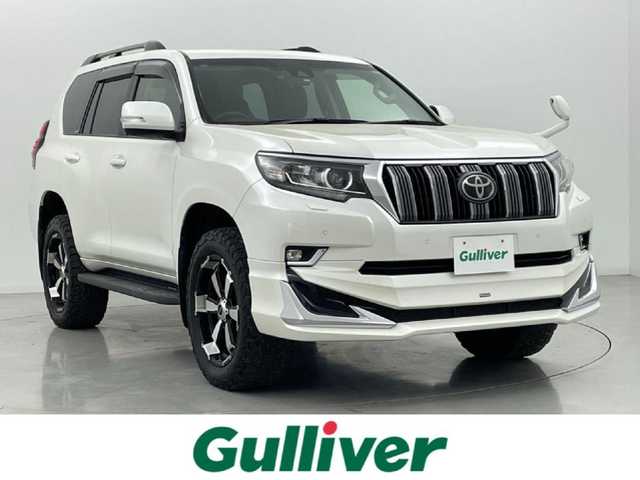 トヨタ ランドクルーザー プラド TX 熊本県 2019(令1)年 3.6万km ホワイトパールクリスタルシャイン 禁煙車　/モデリスタエアロ（Ｆ）/純正ナビ（ＣＤ・ＤＶＤ・フルセグ・ＢＴ・ＳＤ・ＵＳＢ）/バックカメラ　/社外全方位ドライブレコーダー　/ヘッドレスト取り付後席モニター/ビルトインＥＴＣ　/前後クリアランスソナー/レーダークルーズコントロール/衝突軽減ブレーキ/レーンキープアシスト/ダウンヒルアシスト/横滑り防止/ルーフレール/前後クリアランスソナー/ガナドールマフラー/純正フロアマット/RAYS２０インチAW/オートライト/オートマチックハイビーム/LEDヘッドライト/フォグライト/スマートキー/プッシュスタート/スペアキー1本/保証書/取扱説明書