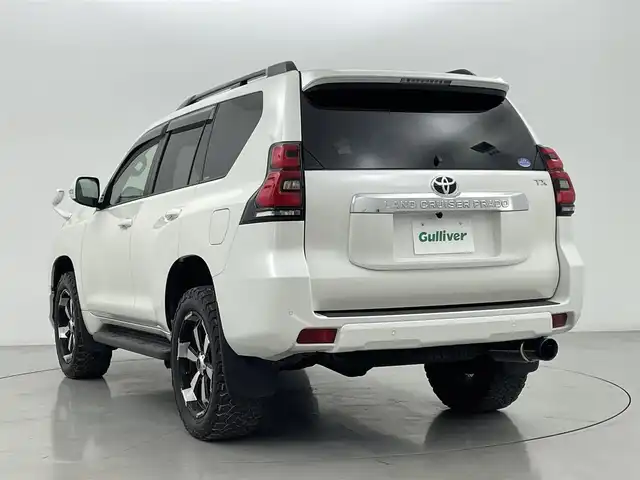 トヨタ ランドクルーザー プラド TX 熊本県 2019(令1)年 3.6万km ホワイトパールクリスタルシャイン 禁煙車　/モデリスタエアロ（Ｆ）/純正ナビ（ＣＤ・ＤＶＤ・フルセグ・ＢＴ・ＳＤ・ＵＳＢ）/バックカメラ　/社外全方位ドライブレコーダー　/ヘッドレスト取り付後席モニター/ビルトインＥＴＣ　/前後クリアランスソナー/レーダークルーズコントロール/衝突軽減ブレーキ/レーンキープアシスト/ダウンヒルアシスト/横滑り防止/ルーフレール/前後クリアランスソナー/ガナドールマフラー/純正フロアマット/RAYS２０インチAW/オートライト/オートマチックハイビーム/LEDヘッドライト/フォグライト/スマートキー/プッシュスタート/スペアキー1本/保証書/取扱説明書
