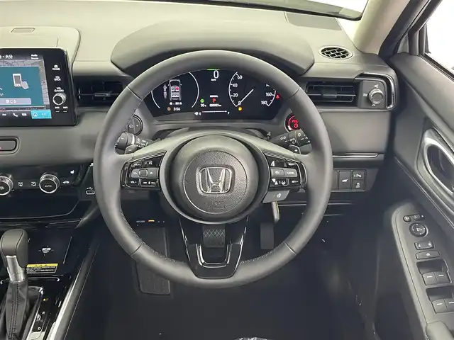 ホンダ ヴェゼル ハイブリッド e:HEV Z 大分県 2025(令7)年 0.1万km未満 プラチナホワイトパール 登録済未使用車/OPフロントグリル（ベルリナブラック）/Honda SENSING/・衝突軽減ブレーキ（CMBS）/・誤発進抑制機能/・後方誤発進抑制機能/・近距離衝突軽減ブレーキ/・歩行者事故低減ステアリング/・路外逸脱抑制機能/・渋滞追従機能付アダプティブクルーズコントロール（ACC）/・車線維持支援システム（LKAS）/・トラフィックジャムアシスト（渋滞運転支援機能）/・先行車発進お知らせ機能/・標識認識機能/・オートハイビーム/・パーキングセンサーシステム/・アダプティブドライビングビーム/・ブラインドスポットインフォメーション/Honda CONNECTディスプレー/・フルセグTV、BT対応、USB、AM/FM/・AppleCarPlay、AndroidAuto/ステアリングスイッチ/バックカメラ/ETC2.0車載器/ワイヤレス充電/ステアリングヒーター/パワーバックドア/横滑り防止装置/電動格納ミラー/ハーフレザーシート/・前席シートヒーター/オートライト/LEDヘッドライト/LEDフォグ/純正18インチアルミホイール/保証書、取説、スペアキー有り