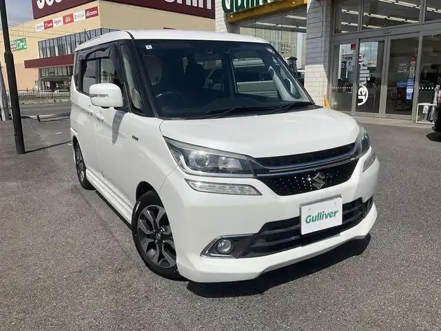 スズキ ソリオ バンディット HV MV Dカメラ ブレーキS 滋賀県 2018(平30)年 9.7万km ピュアホワイトP ワンオーナー/車検9年2月まで/スズキセーティサポート/デュアルカメラブレーキサポート/クルーズコントロール/純正8インチナビ/Bluetooth、CD、DVD、フルセグテレビ/全方位モニター、バックカメラ/ビルトインETC/両側パワースライドドア/運転席シートヒーター/LEDヘッドライト、フォグランプ/2列目パーソナルテーブル/純正15インチアルミホイール/スペアキー有り/取扱説明書、保証書/