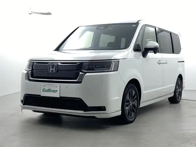 ホンダ ステップワゴン スパーダ eHEV 福井県 2024(令6)年 1.3万km プラチナホワイトパール 純正11インチナビ（LXM-247VFLi）/-フルセグTV/CD/DVD/Bluetooth/USB/AppleCarPlay/AndroidAuto/純正フロアマット/前後ドライブレコーダー/バックカメラ/ホンダセンシング/衝突軽減ブレーキ/BSM/パワーテールゲート/前後コーナーセンサー/両側パワースライドドア/レーダークルーズコントロール/レーンキープアシスト/ハーフレザーシート/前席シートヒーター/オットマン/パドルシフト/トリプルゾーンAC/16インチAW/電子ブレーキ/ブレーキホールド/オートライト/オートハイビーム/LEDヘッドライト/背面テーブル