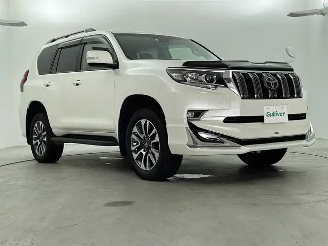 トヨタ ランドクルーザー プラド TX Lパッケージ 福島県 2023(令5)年 1.6万km ホワイトパールクリスタルシャイン 7人乗り/寒冷地仕様/モデリスタエアロ/サンルーフ/ルーフレール/純正OP19インチアルミホイール/純正9インチナビ(CD/DVD/Bluetooth/フルセグTV)/バックカメラ/前後ドライブレコーダー/ベージュレザーシート/前席パワーシート/前席シートヒーター/前席シートベンチレーション/トヨタセーフティーセンス/前後コーナーセンサー/ビルトインETC2.0/スペアキー×1/新車時保証書＆取扱説明書