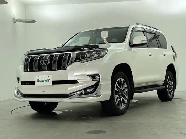 トヨタ ランドクルーザー プラド TX Lパッケージ 福島県 2023(令5)年 1.6万km ホワイトパールクリスタルシャイン 7人乗り/寒冷地仕様/モデリスタエアロ/サンルーフ/ルーフレール/純正OP19インチアルミホイール/純正9インチナビ(CD/DVD/Bluetooth/フルセグTV)/バックカメラ/前後ドライブレコーダー/ベージュレザーシート/前席パワーシート/前席シートヒーター/前席シートベンチレーション/トヨタセーフティーセンス/前後コーナーセンサー/ビルトインETC2.0/スペアキー×1/新車時保証書＆取扱説明書