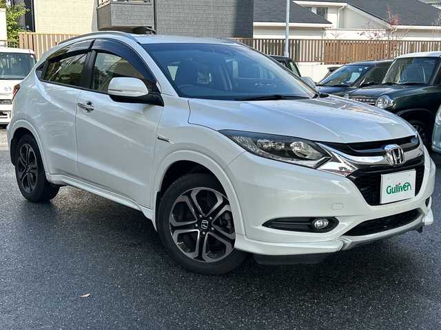 ホンダ ヴェゼル ハイブリッド 福岡県 2016(平28)年 9.2万km ホワイトオーキッドパール 純正ナビ・AM/FM・CD/DVD/フルTV・USB・HDMI・AUX/純正フロアマット/ETC（ビルド）/パドルシフト/クルーズコントロール/シートヒーター（D.N)/ブレーキホールド/横滑り防止/オートライト/車両接近通報装置/ウィンドシールドデアイサー/電動格納ミラー