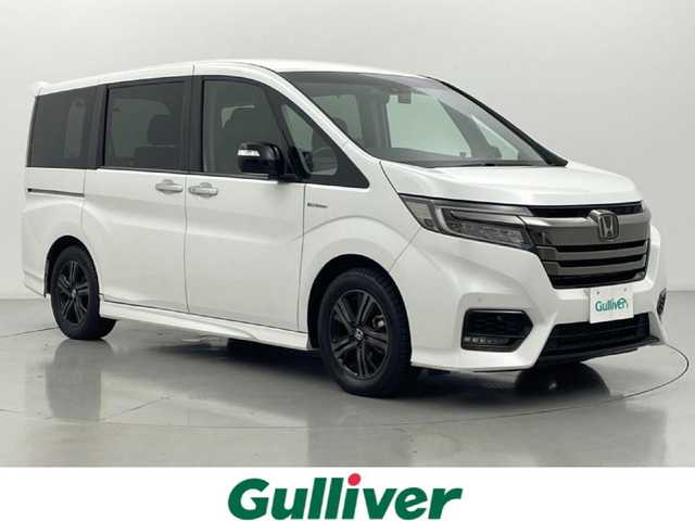 ホンダ ステップワゴン スパーダ ハイブリッド G EX ホンダセンシング 熊本県 2019(令1)年 6.7万km プラチナホワイトパール ワンオーナー　/禁煙車　/社外ナビ　/カロッツェリアフリップダウンモニター　/ビルトインＥＴＣ　/社外前後ドライブレコーダー　/バックカメラ/レーダークルーズコントロール/前後クリアランスソナー　/両側パワースライドドア　/前席シートヒーター　/ＧＰＳレーダー探知機/レーンキープアシスト/横滑り防止/デジタルインナーミラー/フロアマット/純正１６インチAW/オートライト/LEDヘッドライト/フォグライト/スマートキー/プッシュスタート/保証書/取扱説明書