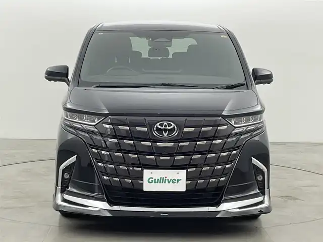 トヨタ アルファードハイブリット Z 福岡県 2024(令6)年 0.7万km ブラック 左右独立ムーンルーフ　/モデリスタエアロ／マフラー　/純正１４型ＤＡナビ／フルセグTV　/全方位カメラ　/ワイヤレス充電　/デジタルルームミラー　/ビルトインETC２．０　/ユニバーサルステップ　/トヨタセーフティセンス　/レーダークルーズコントロール　/コーナーセンサー　/衝突軽減ブレーキ　/レーンキープ　/ブラインドスポットモニター　/アクセル踏み間違い防止　/チームメイトアドバンストパーク　/両側電動スライドドア　/パワーバックドア　/シートベンチレーション／ヒーター　/ステアリングヒーター　/３眼ＬＥＤヘッドライト　/純正１８インチアルミホイール