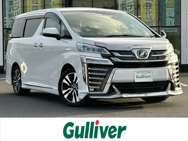 トヨタ ヴェルファイア Z Gエディション 岡山県 2019(平31)年 11.1万km ホワイトパールクリスタルシャイン 登録時走行距離110210km/ワンオーナー/純正8インチナビ/（SD/CD/DVD/Bluetooth）/純正フリップダウンモニター/トヨタセーフティーセンス/・プリクラッシュセーフティ/・レーントレーシングアシスト/・レーダークルーズコントロール/・レーンディパーチャーアラート/・オートマチックハイビーム/・ロードサインアシスト/モデリスタエアロ/ブラインドスポットモニター/パワーシート/エアーシート/シートヒーター/オートブレーキホールド/両側パワースライドドア/純正18インチホイール/ステアリングヒーター/ステアリングスイッチ/プッシュスタート/スマートキー