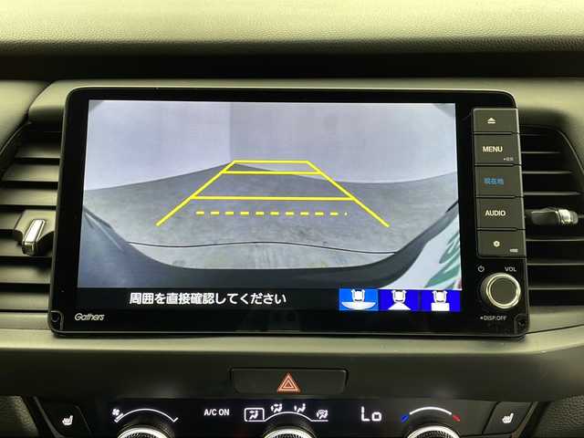 ホンダ フィット e:HEVリュクス 鹿児島県 2020(令2)年 1.8万km シャイニンググレーM ホンダセンシング　/●衝突軽減ブレーキ〈CMBS〉/●誤発進抑制機能/●後方誤発進抑制機能/●近距離衝突軽減ブレーキ/●歩行者事故低減ステアリング/●路外逸脱抑制機能/●渋滞追従機能付アダプティブ・クルーズ・コントロール〈ACC〉/●車線維持支援システム〈LKAS〉/●先行車発進お知らせ機能●標識認識機能/●オートハイビーム/純正９型ナビ　/前後ドライブレコーダー　/電子パーキング　/オートホールド　/ハンドルヒーター　/フォグライト　/LEDヘッドライト/ドアバイザー　/ウインカーミラー　/シートヒーター/ワイヤレス充電器/純正アルミホイール