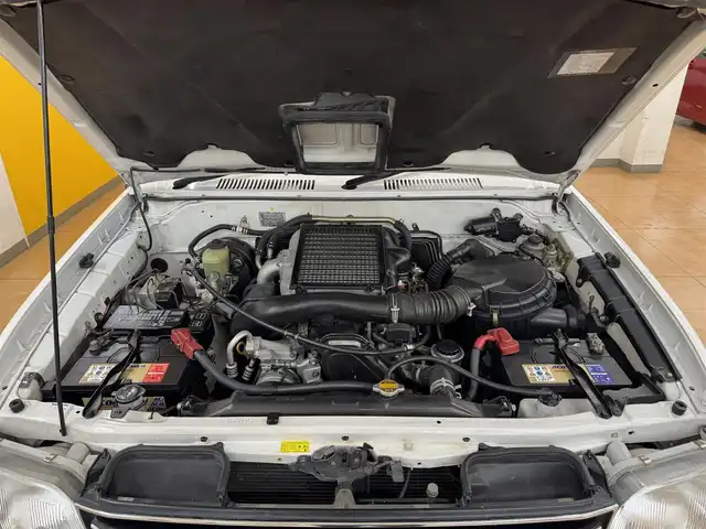トヨタ ランドクルーザー プラド TX ワイド パッケージⅢ 群馬県 1998(平10)年 7.4万km ホワイト/シルバーM 8ナンバー登録/.ベッド【180×50】/・キャンピングタンク/・コンロ/社外SDナビ/　　iPod/USB/SD/CD/DVD/ワンセグ/バックカメラ/サンルーフ/ルーフレール/オートエアコン/シートカバー付/純正16インチアルミ/背面タイヤ/キャンピング/ETC