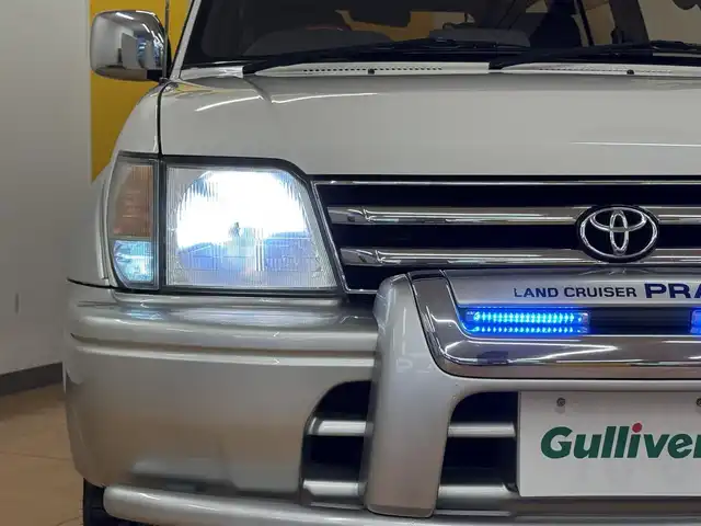 トヨタ ランドクルーザー プラド TX ワイド パッケージⅢ 群馬県 1998(平10)年 7.4万km ホワイト/シルバーM 8ナンバー登録/.ベッド【180×50】/・キャンピングタンク/・コンロ/社外SDナビ/　　iPod/USB/SD/CD/DVD/ワンセグ/バックカメラ/サンルーフ/ルーフレール/オートエアコン/シートカバー付/純正16インチアルミ/背面タイヤ/キャンピング/ETC