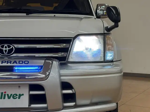 トヨタ ランドクルーザー プラド TX ワイド パッケージⅢ 群馬県 1998(平10)年 7.4万km ホワイト/シルバーM 8ナンバー登録/.ベッド【180×50】/・キャンピングタンク/・コンロ/社外SDナビ/　　iPod/USB/SD/CD/DVD/ワンセグ/バックカメラ/サンルーフ/ルーフレール/オートエアコン/シートカバー付/純正16インチアルミ/背面タイヤ/キャンピング/ETC