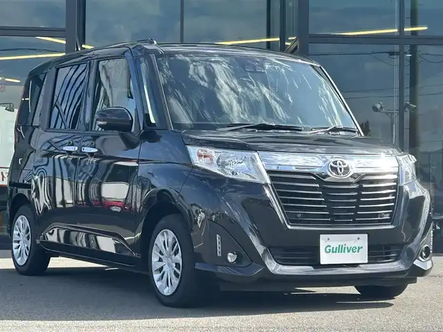 トヨタ ルーミー G－T 愛媛県 2020(令2)年 2.6万km ブラックマイカメタリック 純正9型ナビ/純正12.1型フリップダウンモニター/両側パワースライドドア/純正ドライブレコーダー/バックカメラ/クルーズコントロール/アイドリングストップ/衝突被害軽減装置/車線逸脱防止装置/クリアランスソナー/ステアリングリモコン/後席サンシェイド/電動格納ミラー/ヘッドライトレベライザー/シガーソケット/純正ホイールキャップ/現状サマー(鉄)(165/65/R14)/DUNLOP ENASAVE EC300+/禁煙車
