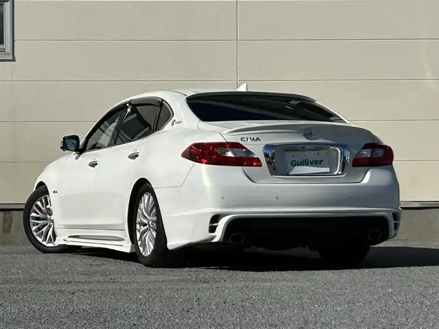 日産 シーマ ハイブリッド VIP G 茨城県 2017(平29)年 7.8万km クリスタルホワイトパール 純正ナビ/（AM/FM/CD/DVD/AUX/Bluetooth）/フルセグ/サンルーフ/BOSEサウンド/後席プライベートシアターシステム/純正アカンサスエンブレム/純正リアスポイラー/エアロパーツ（フロント・サイド）/純正リモコンエンジンスターター/全方位カメラ/電動リアシェード/全席本革パワーシート/シートヒーター（全席）/エアシート（前席）/オットマン（N席）/前方ドライブレコーダー/ビルトインETC/追従型クルーズコントロール/ブラインドスポットモニター/社外サス/純正アルミホイール/純正フロアマット