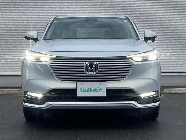 ホンダ ヴェゼル ハイブリッド e:HEV Z 秋田県 2023(令5)年 3.6万km プレミアムサンライトホワイトパール ４WD/衝突軽減システム/LEDヘッドライト/純正メモリナビ（DVD/CD/BT/AM/FM/USB）/フルセグ（走行中視聴可能）/バックカメラ/ホンダ純正１８インチアルミ（夏タイヤ装着）/スマートキー/アイドリングストップ/プッシュスタート/コーナーセンサー/レーンキープアシスト/クルーズコントロール追従走行あり/オートマチックハイビーム/ダウンヒルアシストコントロール/ステアリングスイッチ/ステアリングヒーター/パドルシフト/前席シートヒーター/ビルトインETC/電動リアゲート/電動パーキングブレーキ/オートブレーキホールド機能/純正フロアマット/社外ドアバイザー/オートライト/オートエアコン/パワーステアリング/パワーウィンドウ/横滑り防止/盗難防止装置/寒冷地仕様/電動格納ウィンカーミラー/保証書/取扱説明書/記録簿