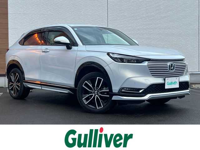 ホンダ ヴェゼル ハイブリッド e:HEV Z 秋田県 2023(令5)年 3.6万km プレミアムサンライトホワイトパール ４WD/衝突軽減システム/LEDヘッドライト/純正メモリナビ（DVD/CD/BT/AM/FM/USB）/フルセグ（走行中視聴可能）/バックカメラ/ホンダ純正１８インチアルミ（夏タイヤ装着）/スマートキー/アイドリングストップ/プッシュスタート/コーナーセンサー/レーンキープアシスト/クルーズコントロール追従走行あり/オートマチックハイビーム/ダウンヒルアシストコントロール/ステアリングスイッチ/ステアリングヒーター/パドルシフト/前席シートヒーター/ビルトインETC/電動リアゲート/電動パーキングブレーキ/オートブレーキホールド機能/純正フロアマット/社外ドアバイザー/オートライト/オートエアコン/パワーステアリング/パワーウィンドウ/横滑り防止/盗難防止装置/寒冷地仕様/電動格納ウィンカーミラー/保証書/取扱説明書/記録簿