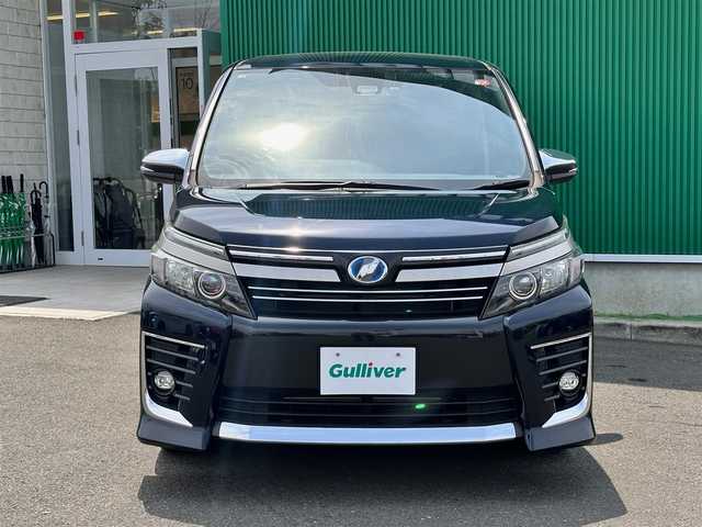 トヨタ ヴォクシー ハイブリッド ZS 煌Ⅱ 宮城県 2016(平28)年 9.5万km ブラッキッシュアゲハガラスフレーク セーフティセンスC/・プリクラッシュセーフティ/・レーンディパーチャーアラート/・オートマチックハイビーム/・先行車発進告知/純正12インチフリップダウンモニター（V12T-R66C）/純正10インチナビ（ZSZN-Z66T）/・CD/DVD/・Bluetooth/・フルセグTV/バックカメラ/ビルトインETC2.0/ドライブレコーダー/両側パワースライドドア/革巻きステアリング/ステアリングスイッチ/LEDヘッドランプ/フォグランプ/オートライト/スマートキー＆プッシュスタート/電動格納ミラー/純正16インチAW/純正フロアマット/純正ドアバイザー/Wエアバッグ