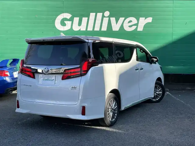 トヨタ アルファードハイブリット S タイプゴールドⅡ 東京都 2021(令3)年 1.7万km ホワイトパールクリスタルシャイン ワンオーナー/純正ナビ/・フルセグTV/Bluetooth/DVD/Tコネクト/JBLプレミアムサウンド/ツインムーンルーフ/フリップダウンモニター/デジタルインナーミラー/パノラミックビューモニター/両側電動スライドドア/電動リアゲート/純正ドライブレコーダー（DRD-H68)/セーフティセンス/レーダークルーズコントロール/レーンキープアシスト/衝突軽減システム/前後コーナーセンサー/LEDライト/フロントフォグランプ/オートハイビーム/オットマン/スペアキー×1/ETC2.0/保証書/取扱説明書/記録簿