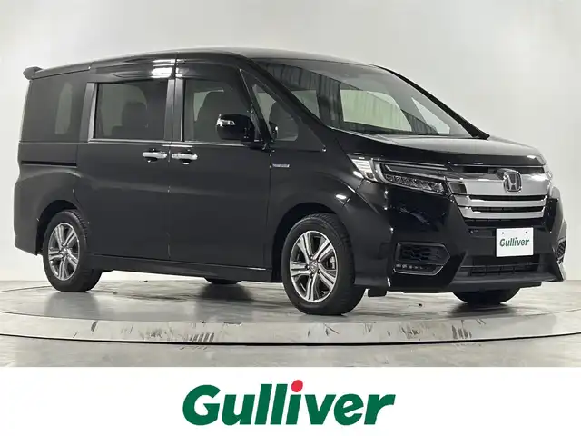ホンダ ステップワゴン スパーダ ハイブリッド G EX ホンダセンシング 佐賀県 2018(平30)年 3.9万km プレミアムスパークルブラックパール 純正10インチナビ/フルセグTV/CD/DVD/Bluetooth/バックカメラ/衝突被害軽減システム/レーダークルーズコントロール/レーンアシスト/横滑り防止装置/ロードサインアシスト/先行車発進お知らせ機能/オートライト/LEDヘッドライト/フォグライト/ビルトインETC/電子パーキング/ブレーキホールド/両側パワースライドドア/ハーフレザーシート/運転席・助手席シートヒーター/後席サンシェード/シートバックテーブル/ISOFIX対応シート/純正フロアマット/純正16インチアルミホイール