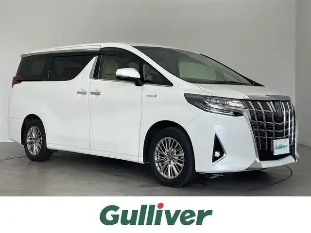 トヨタ アルファードハイブリット G Fパッケージ 埼玉県 2018(平30)年 3.5万km ホワイトパールクリスタルシャイン ４WD/純正メーカーオプションナビ/CD/DVD/Bluetooth/フルセグ/後席用フリップダウンモニター/デジタルインナーミラー/パノラミックビューモニター/トヨタセーフティセンス/・プリクラッシュセーフティ/・レーントレーシングアシスト/・レーダークルーズコントロール/・ロードサインアシスト/・オートマチックハイビーム/ブラインドスポットモニター/先行車発進告知/ビルトインETC2.0/パワーバックドア/レザーシート/前席パワーシート/前席シートヒーター/エアシート/純正17インチAW/オートライト/２限LEDヘッドライト/社外AW付きスタッドレスタイヤ４本積込