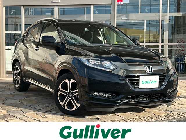 ホンダ ヴェゼル ハイブリッド Z ホンダセンシング 静岡県 2018(平30)年 7.2万km クリスタルブラックパール 社外ナビ（AM FM DTV Bluetooth SD DVD フルセグ USB ipod）/バックカメラ/アダプティブクルーズコントロール/ハーフレザーシート/シートヒーターD＋N席/チップアップシート/ドライブレコーダー/ヒーテッドドアミラー/ステアリングリモコンアダプター/ブレーキホールド/ETC/純正アルミホイール/社外フロアマット/LEDヘッドライト/フォグランプ/Wエアバッグ/カーテンエアバッグ/スマートキー/スペアキー×１/取扱説明書/保証書