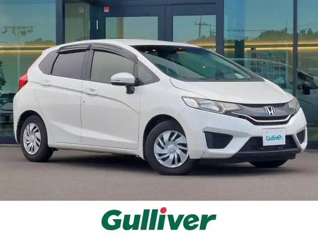 ホンダ フィット 13G Fパッケージ 東京都 2015(平27)年 6.4万km プレミアムホワイトパール 純正ナビ/（ワンセグTV/FM/AM/Bluetooth/CD/DVD/SD）/ETC/純正フロアマット/横滑り防止装置/ステアリングスイッチ/電動格納ウインカーミラー/リアプライバシーガラス/オートライト/ライトレべライザー/ドアバイザ―/スマートキー/プッシュスタート