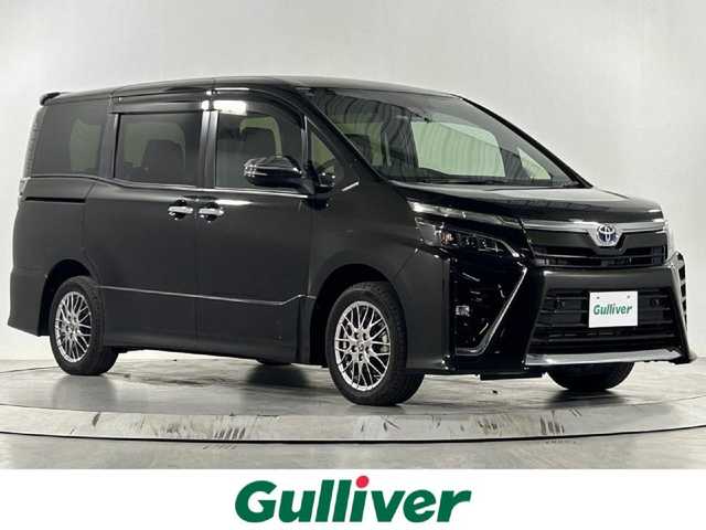 トヨタ ヴォクシー ハイブリッド ZS 煌Ⅲ 佐賀県 2021(令3)年 5.2万km イナズマスパーキングブラックガラスフレーク 純正9型ナビ/AM/FM/Bluetooth/SD/CD/DVD/フルセグTV/クルーズコントロール/バックカメラ/ETC/前後ドライブレコーダー/ウォークスルー/純正フロアマット/ハーフレザーシート/シートヒーター/両側パワースライドドア/純正16インチAW/横滑り防止装置/コーナーセンサー/レーンアシスト/プリクラッシュセーフティ/先行車発進告知機能/オートライト/オートマチックハイビーム/ステアリングリモコン/バイザー/電動格納ミラー