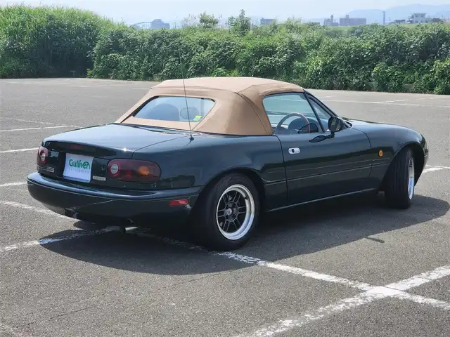 ユーノス ロードスター Vスペシャル 福岡県 1992(平4)年 9.2万km 緑 社外CDステレオ/（Bluetooth、UBS入力）/ナルディ製ステアリング/ナルディ製シフトノブ/ウッドサイドブレーキノブ/Vスペシャルフロアマット/社外14インチアルミホイール/TEIN減衰力調整付車高調/・MAQｓスプリング（70.180.10）/　に組み替え済み/・TEINスプリングは車内積込み/リアスクリーン（ガラス製）/ボディーカバー（車内積み）/泥よけ（車内積み）/トノカバー（車内積み）/取扱説明書/ETC