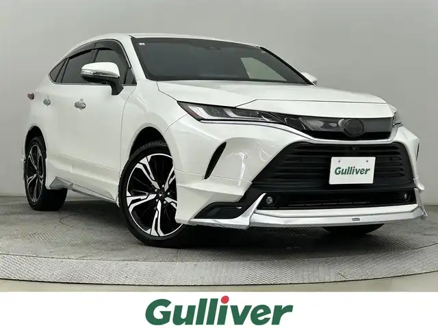 トヨタ ハリアー ハイブリッド Z レザーパッケージ 道央・札幌 2021(令3)年 2.7万km ホワイトパールクリスタルシャイン ・４WD/・モデリスタエアロ/・モデリスタ20インチAW/・JBLサウンド/・純正ディスプレイオーディオ/　BT/USB/Miracast/フルセグ/・パノラミックビューモニター/・デジタルインナーミラー/・ビルトインETC2.0/・AC100V/・トヨタセーフティセンス/・プリクラッシュセーフティ/・レーダークルーズコントロール/・レーンキープアシスト/・オートハイビーム/・クリアランスソナー/・BSM/・HUD/・RCTA/・RSA/・レザーシート/・前席パワーシート/・前席エア/シートヒーター/・パワーバックドア/・LEDヘッドライト/・フォグライト/・オートライト/・プッシュスタート/・スマートキー/・純正フロアマット/・ドアバイザー
