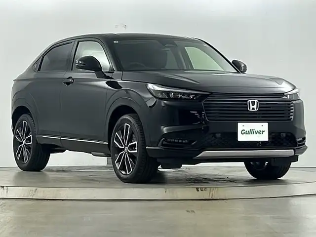 ホンダ ヴェゼル ハイブリッド e:HEV Z 愛知県 2025(令7)年 0.1千km クリスタルブラックパール 登録済未使用車/純正9インチナビ/（AM/FM/フルセグTV/Bluetooth）/バックカメラ/ワイヤレス充電/ホンダセンシング/・衝突軽減ブレーキ/・レーンキープアシスト/・レーダークルーズコントロール/・オートマチックハイビーム/・クリアランスソナー/ブラインドスポットモニター/ETC2.0/シートヒーター/ステアリングヒーター/チップアップシート/ハーフレザー/パドルシフト/パワーバックドア/スマートキー/プッシュスタート/LEDヘッドライト/フロントフォグランプ/ダウンヒルアシスト/純正アルミホイール/横滑り防止装置/電動格納ミラー/ステアリングスイッチ