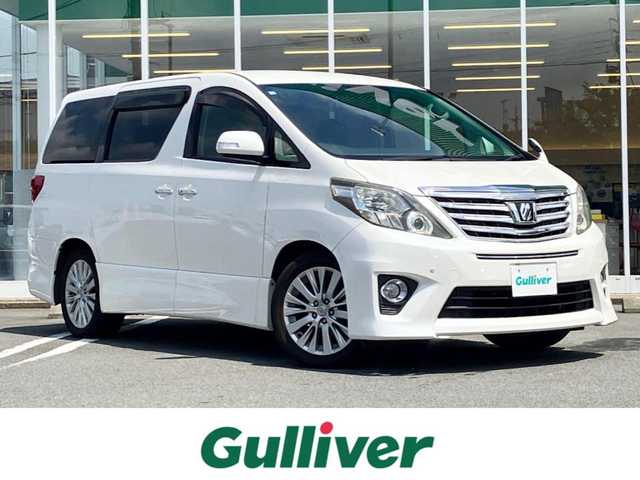 トヨタ アルファード 240S Cパッケージ 静岡県 2012(平24)年 5.7万km ホワイトパールクリスタルシャイン 純正HDDナビ（CD/DVD/BT/フルセグ）/バックカメラ/純正後席用モニター/電動リアゲート/D席N席パワーシート/ETC/２列目電動リクライニングシート/２列目電動オットマン/N席電動オットマン/三列シート/ウォークスルー/純正フロアマット/純正アルミホイール/エンジンスタートボタン/パワーステアリング/パワーウィンドウ/Wオートエアコン/スマートキー/スペアキー１本/クルーズコントロール/両側パワースライドドア/コーナーセンサー前後/ABS/横滑り防止装置/オートライト/W＋サイドエアバック/カーテンエアバック