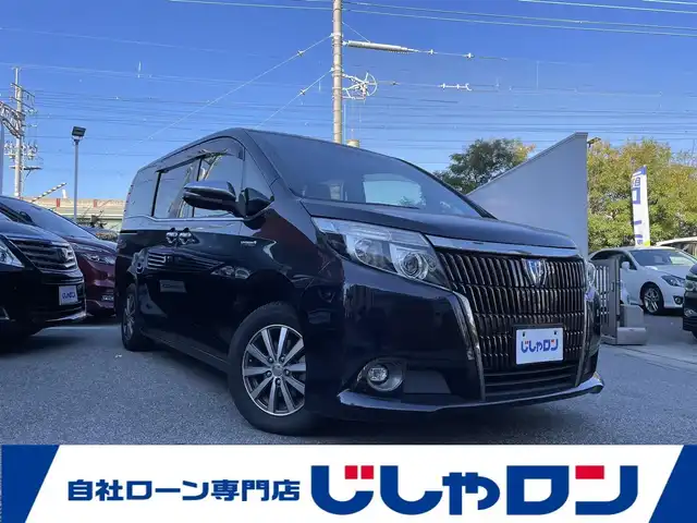 トヨタ エスクァイア ハイブリッド Gi ブラックテーラード 兵庫県 2016(平28)年 12.6万km スパークリングブラックパールクリスタルシャイン (株)IDOMが運営する【じしゃロン西宮店】の自社ローン対象車両になります。こちらは現金ご利用時の価格です。/自社ローンご希望の方は別途その旨お申付け下さい。/＊ETC/＊バックカメラ/＊パワステ/＊パワーウィンドウ/＊クルーズコントロールあり/＊純正10インチナビ/＊ドラレコあり/＊レザーシート/＊シートヒーター/＊エアシート/＊両側パワステ/＊横滑り防止装置/＊レーンキープアシスト/＊オートライト/＊衝突被害軽減システム