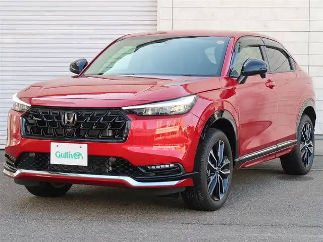 ホンダ ヴェゼル ハイブリッド e:HEV Z 石川県 2025(令7)年 0.3万km プレミアムクリスタルレッドM プッシュスタート/スマートキー2本/アクティブクルーズコントロール/ステアリングヒーター/パーキングセンサー/ハンズフリーアクセスパワーゲート/パドルシフト/ビルトインETC/Fシートヒーター/FRソナーセンサー/黒ハーフレザーシート/ヒルディセントコントロール/アダプティブドライビングビーム/ドアバイザー/Fフォグランプ/純正フロアマット