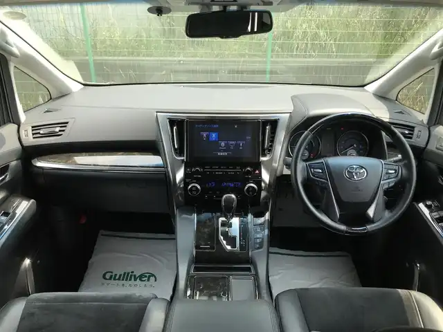 トヨタ アルファードハイブリット SR 秋田県 2016(平28)年 8万km グレーメタリック 4WD/純正9.2型メーカーOPナビ/　(Bluetooth/DVD/Blu-ray)/フルセグTV/両側パワースライドドア/パワーバックドア/パノラミックビューモニター/ビルトインETC/純正12.1型リアエンターテインメントシステム/レーダークルーズコントロール/インテリジェントクリアランスソナー/プリクラッシュセーフティシステム/ビークルスタビリティコントロール/LEDヘッドランプ/オートライト/デュアルオートエアコン/木目調/革巻きコンビステアリング/合皮/ファブリックコンビシート/前席パワーシート/2列目リラックスキャプテンシート/運転席ポジションメモリー/助手席パワーオットマン/純正17インチアルミホイール/スマートエントリー/プッシュスタートシステム/JBLプレミアムサウンドシステム/バルミナ17インチAWスタッドレス積込/禁煙車