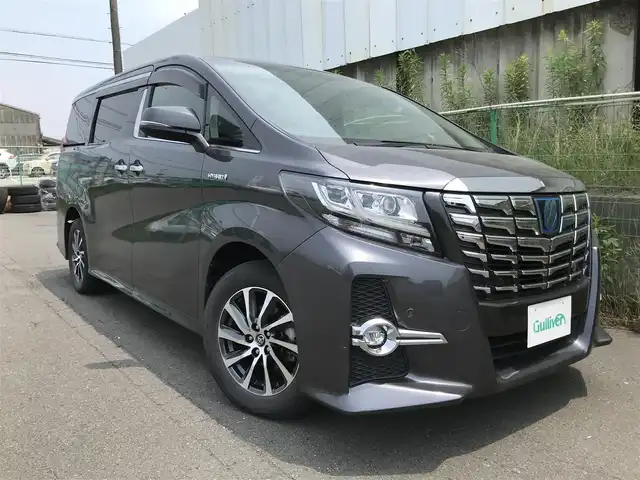 トヨタ アルファードハイブリット SR 秋田県 2016(平28)年 8万km グレーメタリック 4WD/純正9.2型メーカーOPナビ/　(Bluetooth/DVD/Blu-ray)/フルセグTV/両側パワースライドドア/パワーバックドア/パノラミックビューモニター/ビルトインETC/純正12.1型リアエンターテインメントシステム/レーダークルーズコントロール/インテリジェントクリアランスソナー/プリクラッシュセーフティシステム/ビークルスタビリティコントロール/LEDヘッドランプ/オートライト/デュアルオートエアコン/木目調/革巻きコンビステアリング/合皮/ファブリックコンビシート/前席パワーシート/2列目リラックスキャプテンシート/運転席ポジションメモリー/助手席パワーオットマン/純正17インチアルミホイール/スマートエントリー/プッシュスタートシステム/JBLプレミアムサウンドシステム/バルミナ17インチAWスタッドレス積込/禁煙車