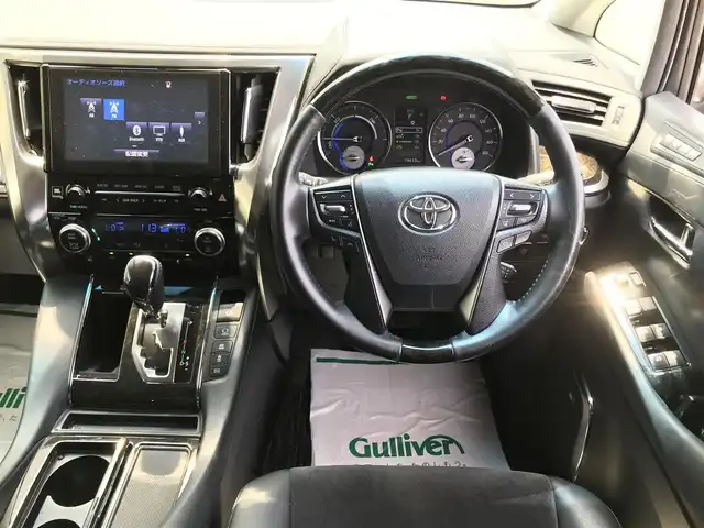 トヨタ アルファードハイブリット SR 秋田県 2016(平28)年 8万km グレーメタリック 4WD/純正9.2型メーカーOPナビ/　(Bluetooth/DVD/Blu-ray)/フルセグTV/両側パワースライドドア/パワーバックドア/パノラミックビューモニター/ビルトインETC/純正12.1型リアエンターテインメントシステム/レーダークルーズコントロール/インテリジェントクリアランスソナー/プリクラッシュセーフティシステム/ビークルスタビリティコントロール/LEDヘッドランプ/オートライト/デュアルオートエアコン/木目調/革巻きコンビステアリング/合皮/ファブリックコンビシート/前席パワーシート/2列目リラックスキャプテンシート/運転席ポジションメモリー/助手席パワーオットマン/純正17インチアルミホイール/スマートエントリー/プッシュスタートシステム/JBLプレミアムサウンドシステム/バルミナ17インチAWスタッドレス積込/禁煙車