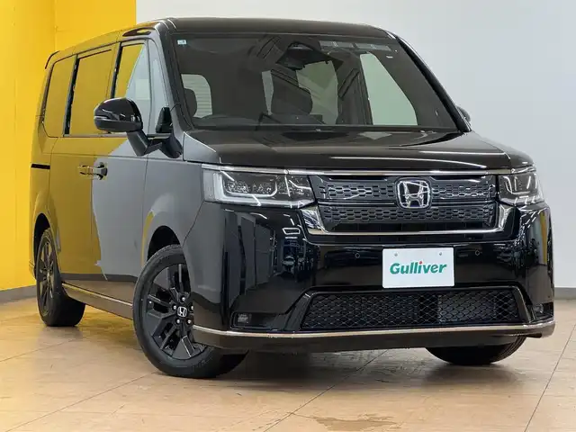 ホンダ ステップワゴン スパーダ eHEV 群馬県 2025(令7)年 0.1万km クリスタルブラックパール ホンダセンシング/・衝突軽減ブレーキ/・誤発進抑制機能/・歩行者事故低減ステアリング/・車線維持支援システム/・路外逸脱抑制機能/・標識認識機能/・先行車発進お知らせ機能/・アダプティブクルーズコントロール/・後方誤発進抑制機能/・近距離衝突軽減ブレーキ/・トラフィックジャムアシスト/・ブラインドスポットインフォメーション/・オートハイビーム/・アダプティブドライビングビーム/社外11インチナビ/・フルセグTV/・Bluetooth/・AUX/パワーバックドア/両側電動スライドドア/ハーフレザーシート/前席シートヒーター/パドルシフト/革巻きステアリング/ステアリングスイッチ/USBポート/スマートキー/プッシュスタート/LEDヘッドライト/フォグランプ/オートライト/ヘッドライトレベライザー/純正16インチAW/電動格納ウィンカーミラー