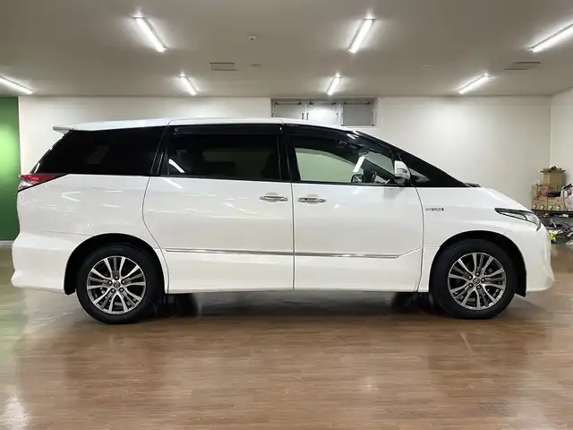 トヨタ エスティマ ハイブリッド アエラス スマート 道央・札幌 2016(平28)年 7.9万km ホワイトパールクリスタルシャイン 4WD/純正SDナビ/・フルセグTV/CD/DVD/BT/SD/バックカメラ/両側パワースライドドア/合成皮革シート/前席シートヒーター/運転席パワーシート/クルーズコントロール/ビルトインETC/衝突被害軽減ブレーキ/レーンキープアシスト/横滑り防止装置/オートマチックハイビーム/プッシュスタート/スマートキー/純正フロアマット/純正ドアバイザー/ウインカーミラー/オートライト/LEDヘッドライト/AC100V電源/2列目オットマン/3列シート/純正17インチAW/保証書/取扱説明書/ナビ説明書